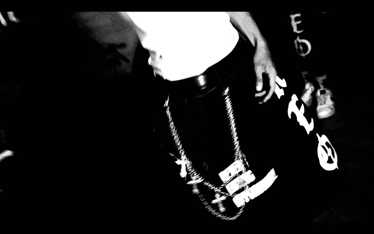 Close-up of a Neo chain and tee in high-contrast black and white